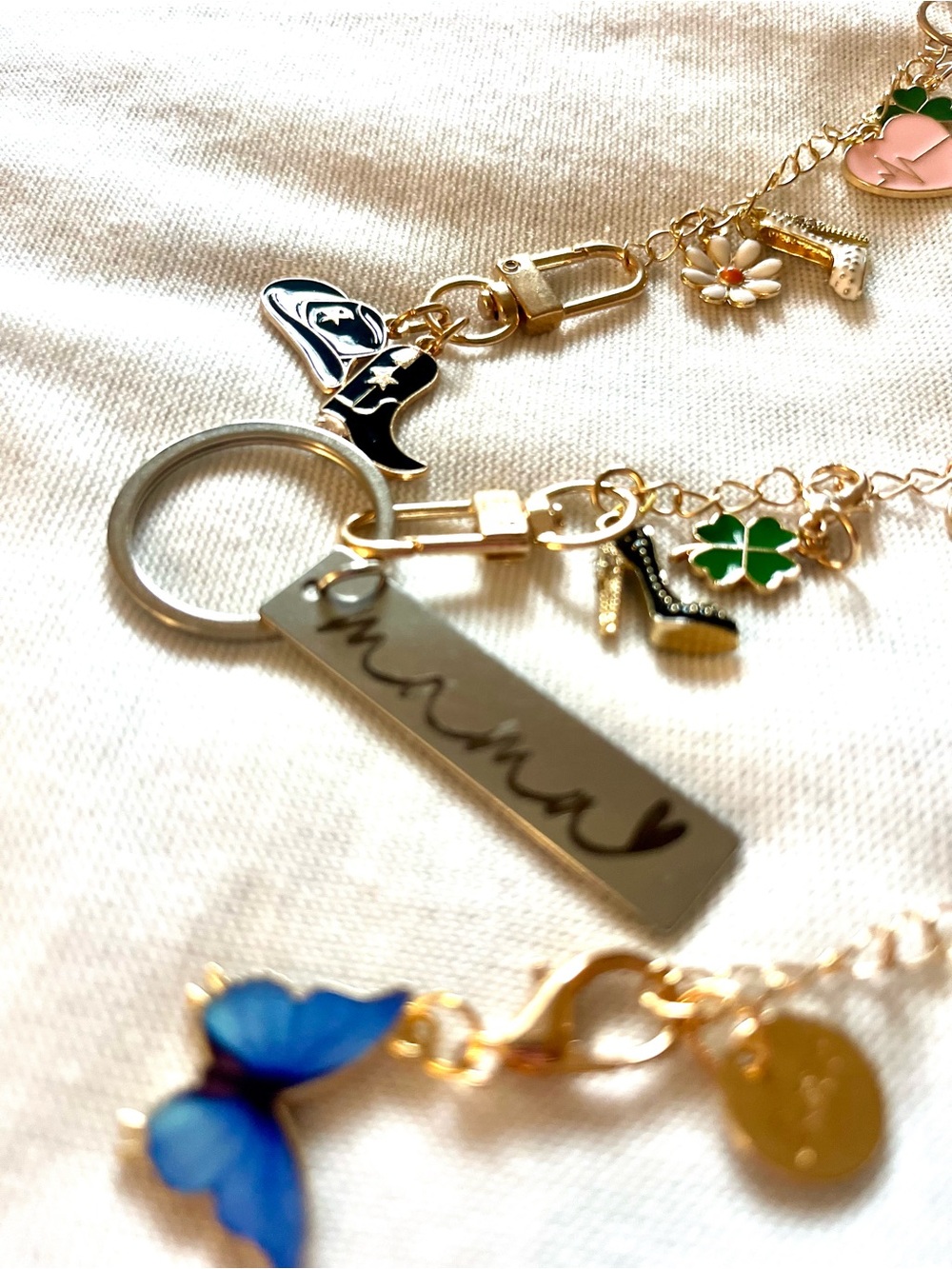 3 Gold Charm Keychains with Blue Butterfly and Green Clover Accents